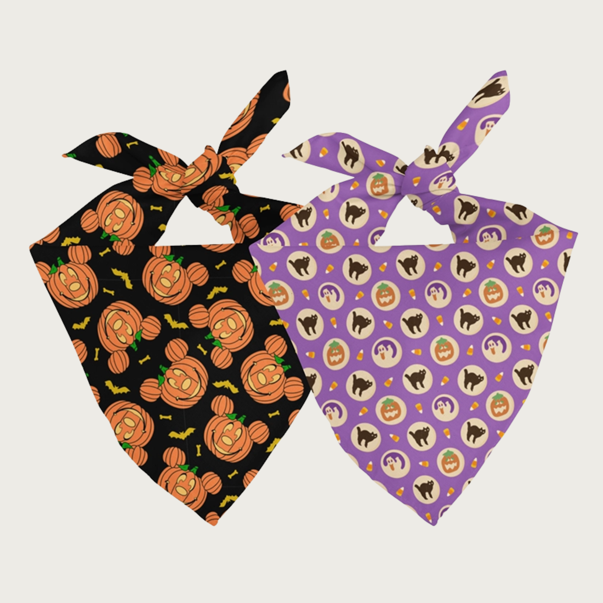 Two sides of the same dog bandana, shown side by side. The background color on the first side is lavender, and it features what looks like slice & bake sugar cookies with black cat, ghost, and jack-o-lanterns in the middle. The background color on the other side is black, and smiling dog-shaped jack-o-lanterns are featured.