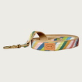 Load image into Gallery viewer, Dog leash with a colorful, diagonal striped pattern, in numerous shades of muted blues, greens, browns, pinks, and ivory. Has a tan cotton underside and brass claw-style clasp.