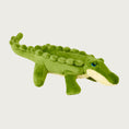 Load image into Gallery viewer, Plush Savannah Baby Gator dog toy from Fluff & Tuff. Toy looks like a baby alligator. It is a medium shade of green on top, and underneath it is pale yellow, with blue eyes.