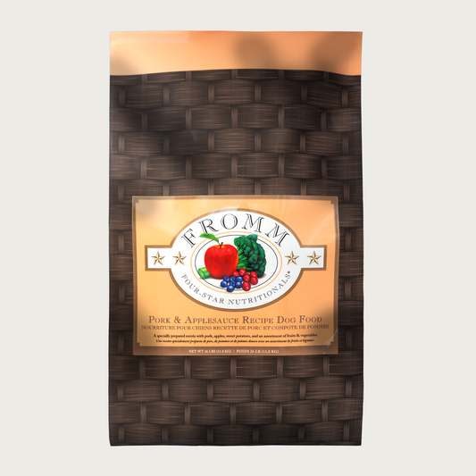 A 26 pound black and tan bag of Fromm Pork & Applesauce Recipe dog food.