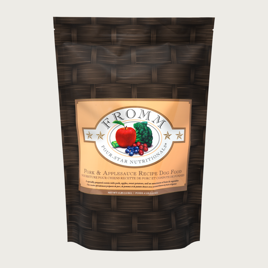 A 4 pound black and tan bag of Fromm Pork & Applesauce Recipe dog food.