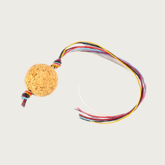 This is a natural cork ball, with strands of brightly colored, natural hemp twine strung through the center.