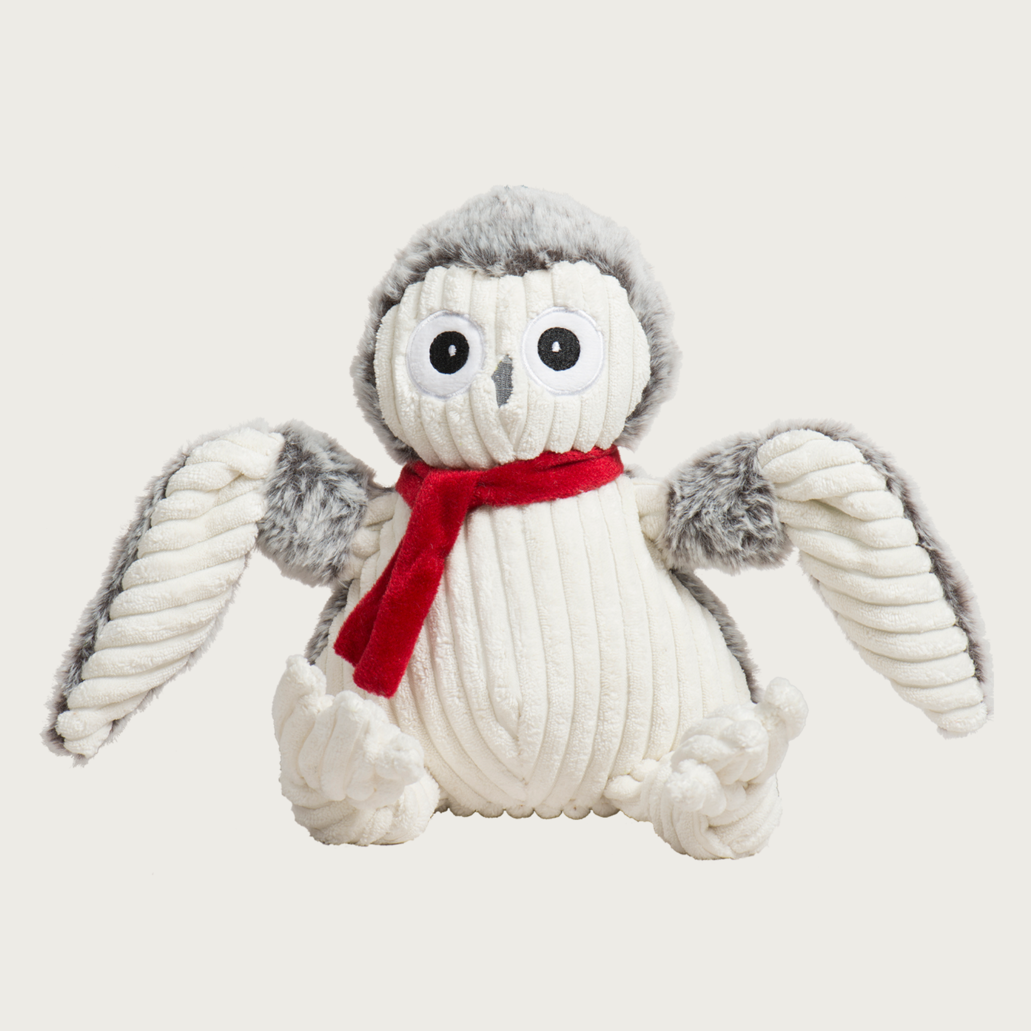 Plush owl dog toy with a red scarf. Front part of its body is cream corduroy, and the back is a light gray plush. Embroidered facial details.