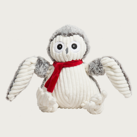 Plush owl dog toy with a red scarf. Front part of its body is cream corduroy, and the back is a light gray plush. Embroidered facial details.