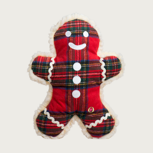 Red Stewart plaid gingerbread man dog toy, with embroidered white facial and decorative accents.