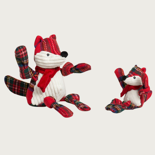 Small and large Tartan Tidings Fox dog toys sitting side by side to show size difference.