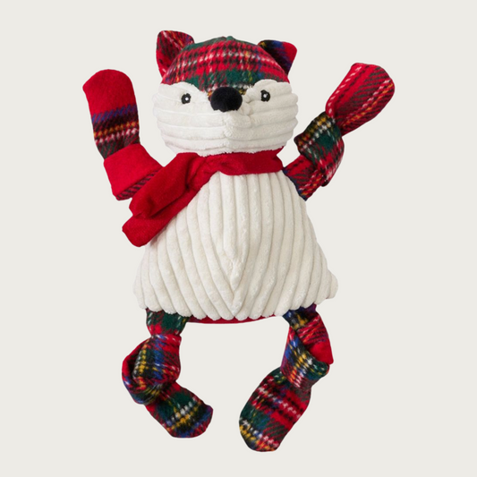 Plush fox dog toy with red tartan plaid head & limbs, and cream corduroy body. It's also wearing a red scarf.