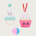 Load image into Gallery viewer, Three birthday themed cat toys. On the left is a plush party hat with seafoam green pom pom and trim, with a cotton rope "chin strap", on the right is a pink smiling plush cupcake with ribbon coming out of the top, and on the bottom is a pink & blue foam ball.