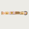 Load image into Gallery viewer, 1in width, dog collar with geometric, smiling sunshine face pattern in shades of orange and pink, on a cream background with stainless d-ring and black plastic buckle.