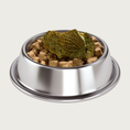 Load image into Gallery viewer, Stainless steel bowl filled with dry pet food, with green tripe pieces on top. The tripe is olive green in color and has a honeycomb-like texture.