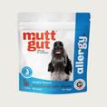 Load image into Gallery viewer, White resealable bag with bright blue accents, of Mutt Gut Allergy & Immune Allergy Functional Soft Chews for Dogs. Features an off-center photo of a dog's snout pointed up, with its tongue slightly sticking out. Promotes healthy histamine levels. Pumpkin flavored. 60 count.
