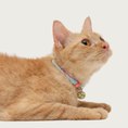 Load image into Gallery viewer, Side view of an orange cat wearing the Chirimen collar in Baby Blue.