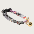 Load image into Gallery viewer, Cat collar with a black, gray, white, purple & coral Asian-inspired geometric/floral print. Each knotted end has a loop for adjusting the collar's size up or down. A gold bell in the shape of a cat's head is attached.