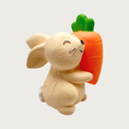 Load image into Gallery viewer, Small light beige latex bunny dog toy with closed eyes, holding a large carrot.