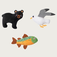 Load image into Gallery viewer, Three small plush toys: a black bear, a white & gray seagull, and a green & brown fish.