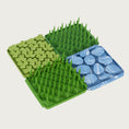 Load image into Gallery viewer, Image of four of the Foraging Mats interlocked together. Two of the Grass design, one of the Clover design, and one of the Rock design. They connect to make a larger area with varying textures.