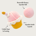Load image into Gallery viewer, Birthday Cupcake toy with the removable pale pink plush covered ball next to it. Text pointing to the cupcake frosting says "crinkle paper in frosting", text pointing to the cupcake base says "squeaker inside cupcake" and text pointing to the ball says "removable bouncy squeaker ball".