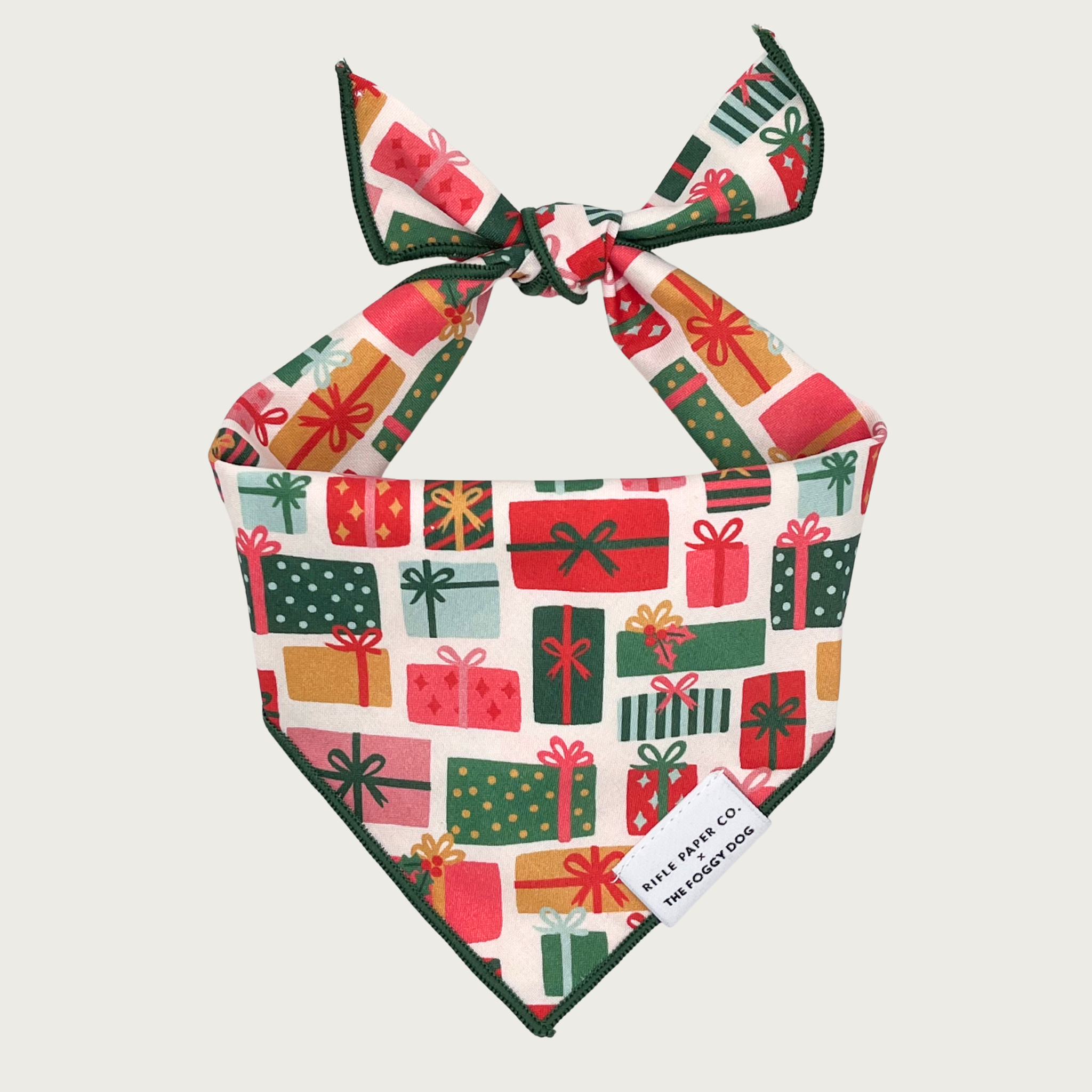 Christmas-themed dog bandana by The Foggy Dog, featuring holiday gift boxes in different shapes & sizes, in various seasonal colors.