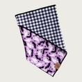 Load image into Gallery viewer, View of the bandana, folded over to show the reverse side (small black & white check) in addition to the front.