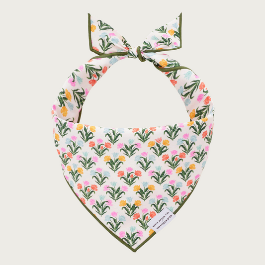 Floral patterned dog bandana, featuring small groups of tulips in various spring colors.