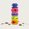 Load image into Gallery viewer, A colorful stack of five different styles of PlayStack dog toys all connected, and standing straight up, each filled with a different type of treat. There are also treat pieces scattered on the floor around it.