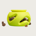 Load image into Gallery viewer, A bright lime green rubber pet puzzle toy with wavy cutouts, shown filled with brown kibble pieces.