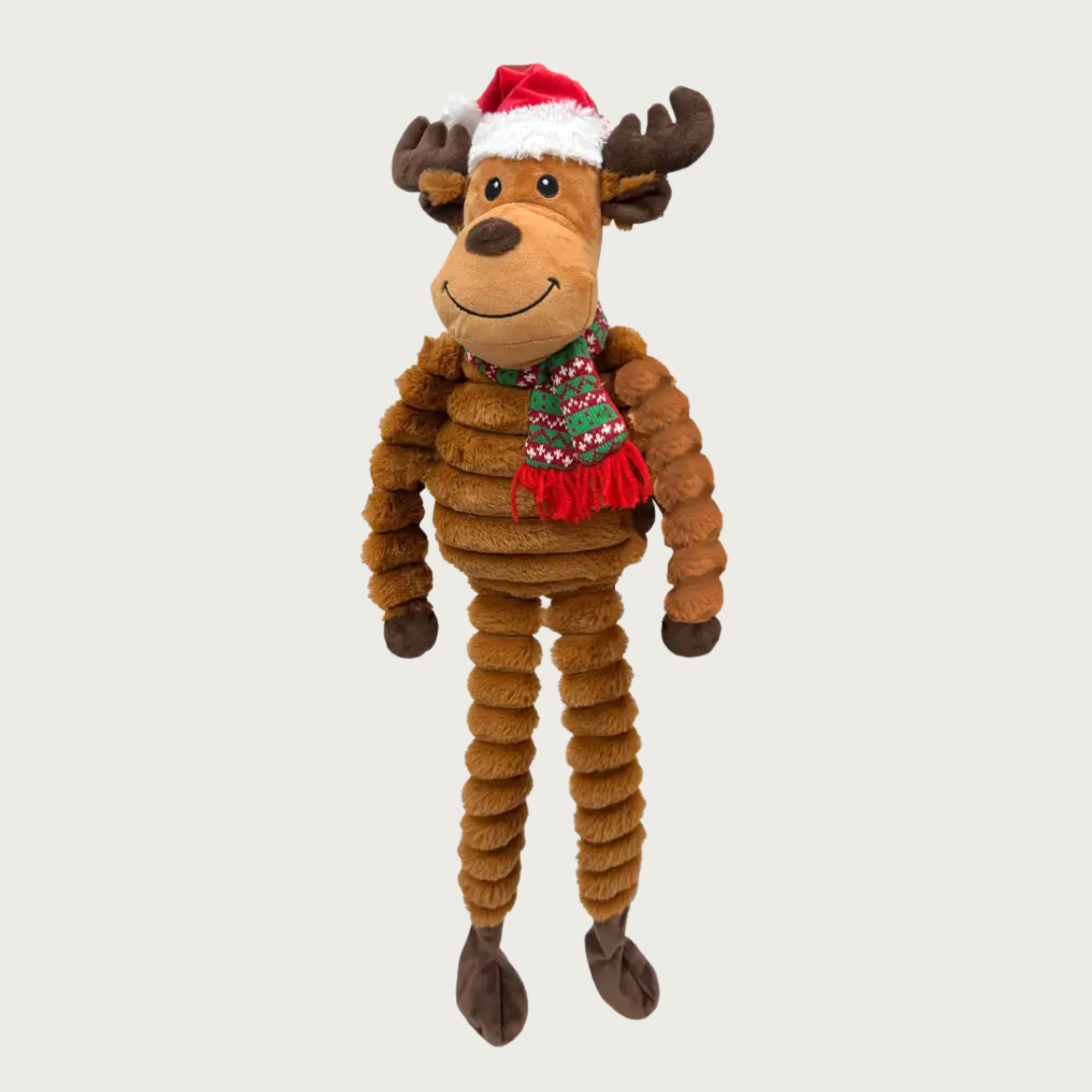 Plush reindeer dog toy wearing a Santa hat and red & green Nordic print scarf. Embroidered facial details. Body, arms & legs are textured plush, similar to corduroy.