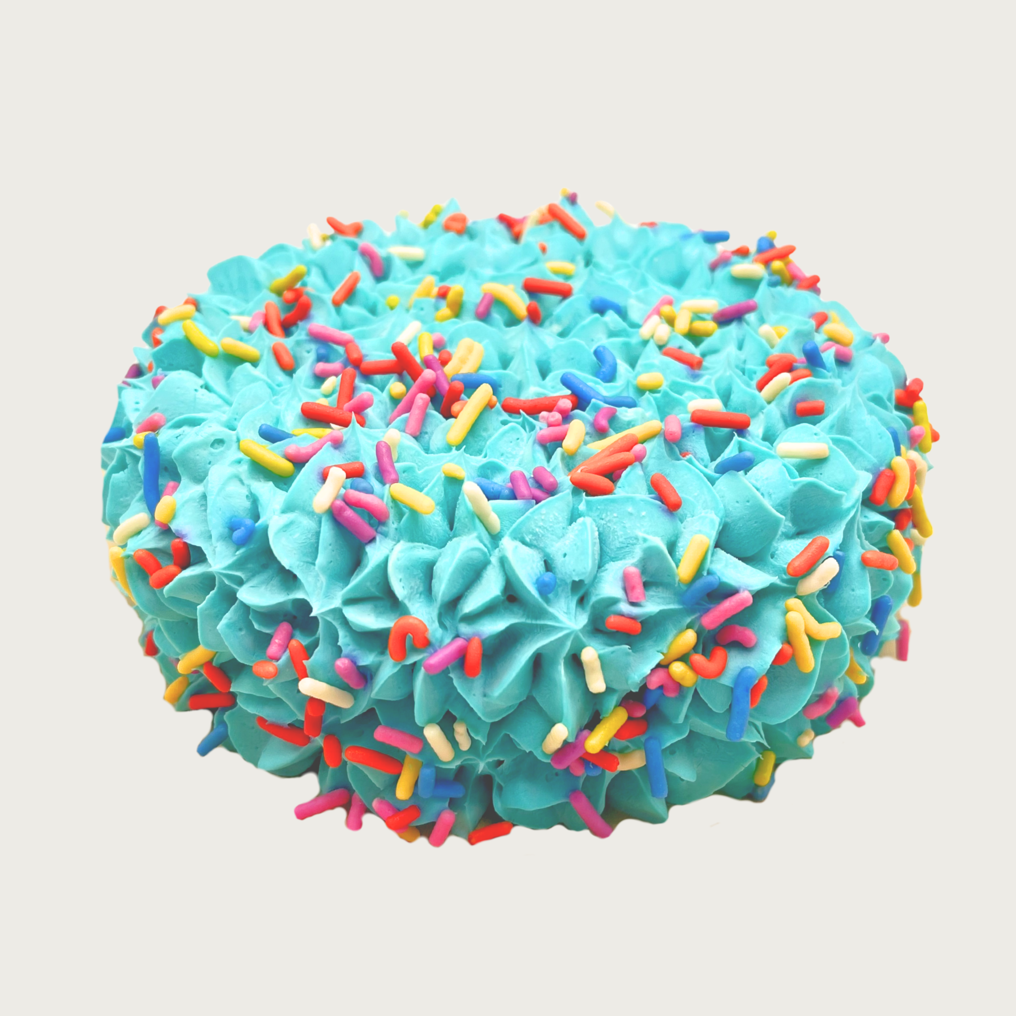 Bright teal blue frosted dog cake with textured frosting & multicolored sprinkles.