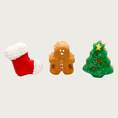 Load image into Gallery viewer, Three Christmas-themed dog cookies shaped like a Christmas tree with ornaments, decorated gingerbread man, and red & white stocking.