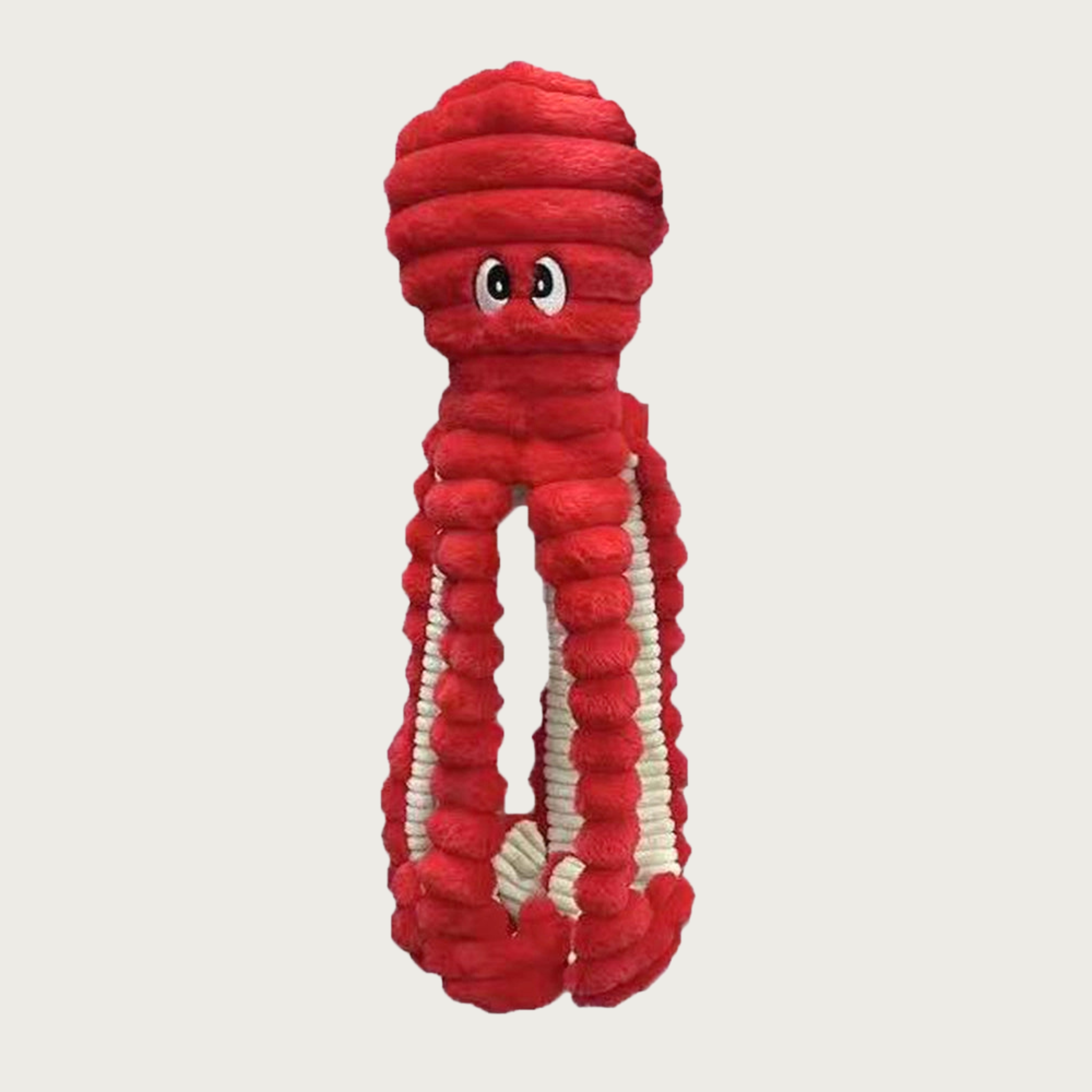 Red textured plush dog toy with googly embroidered eyes. Inner side of legs is beige.