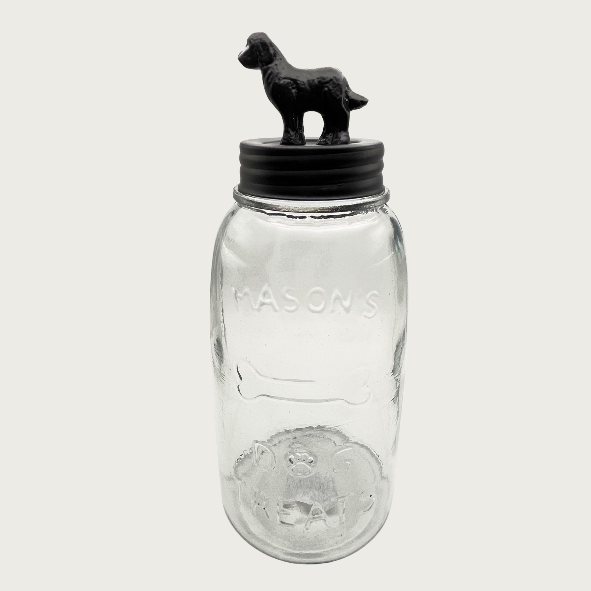 Clear glass mason style treat jar with dark bronzed metal lid. Lid has a 3D figure on top that's about 2.5" tall, and resembles a golden retriever-type dog.