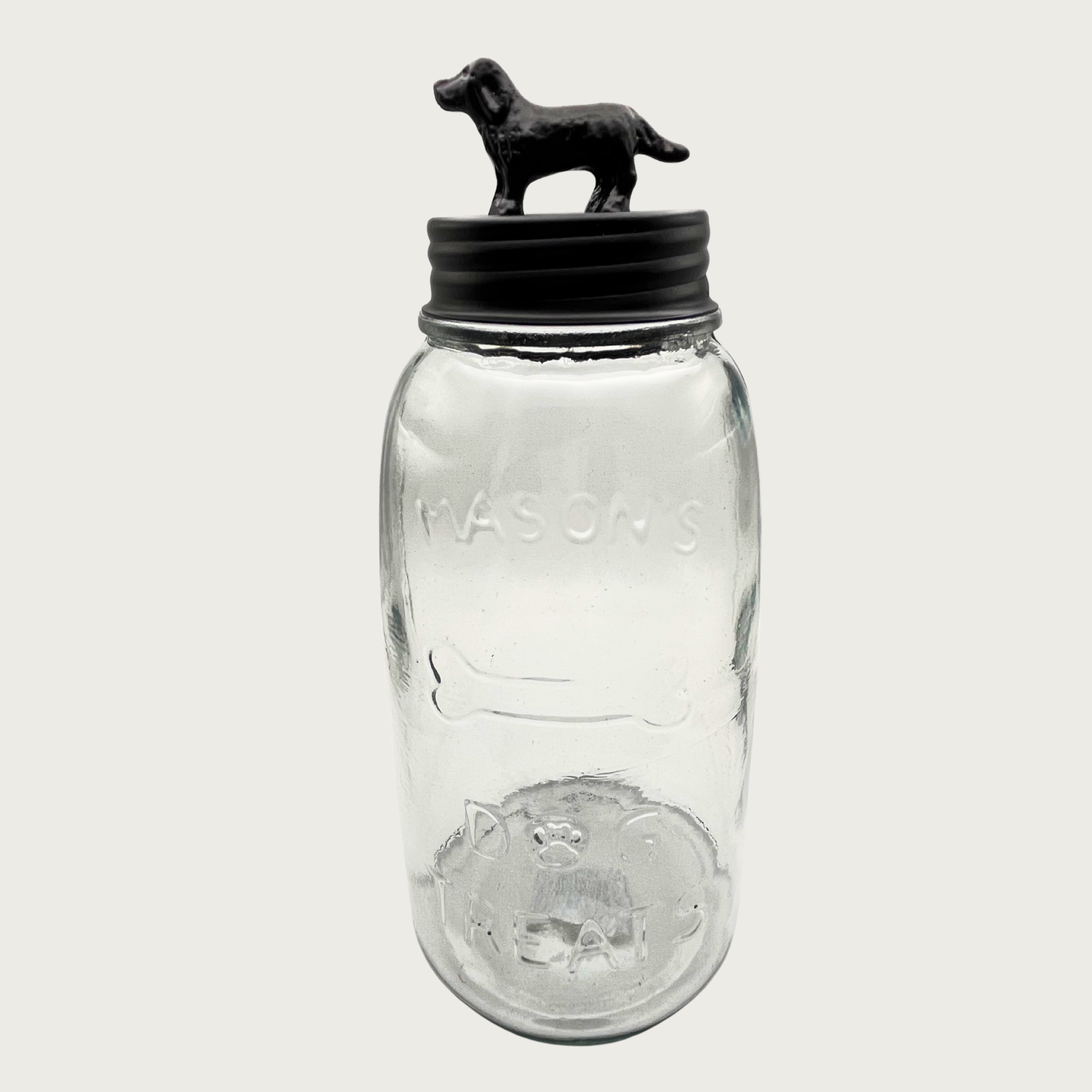 Clear glass mason style treat jar with dark bronzed metal lid. Lid has a 3D figure on top that's about 2.5" tall, and resembles a labrador retriever-type dog.