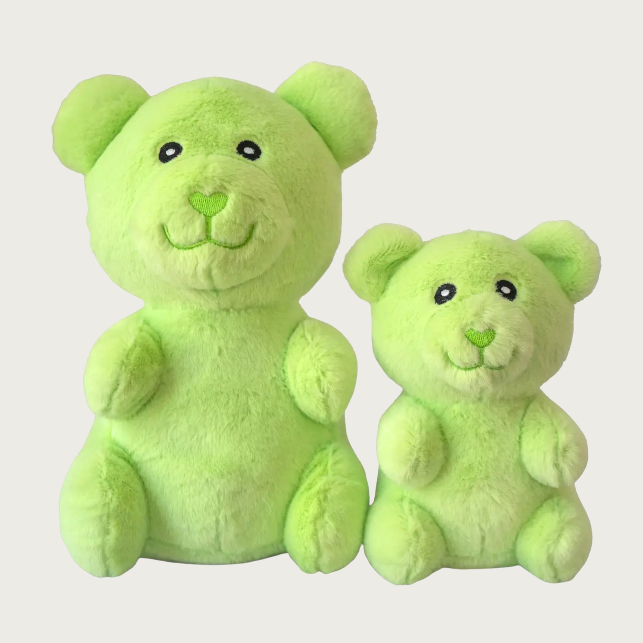 Two plush light lime green gummy bear shaped dog toys, side by side to show size difference.