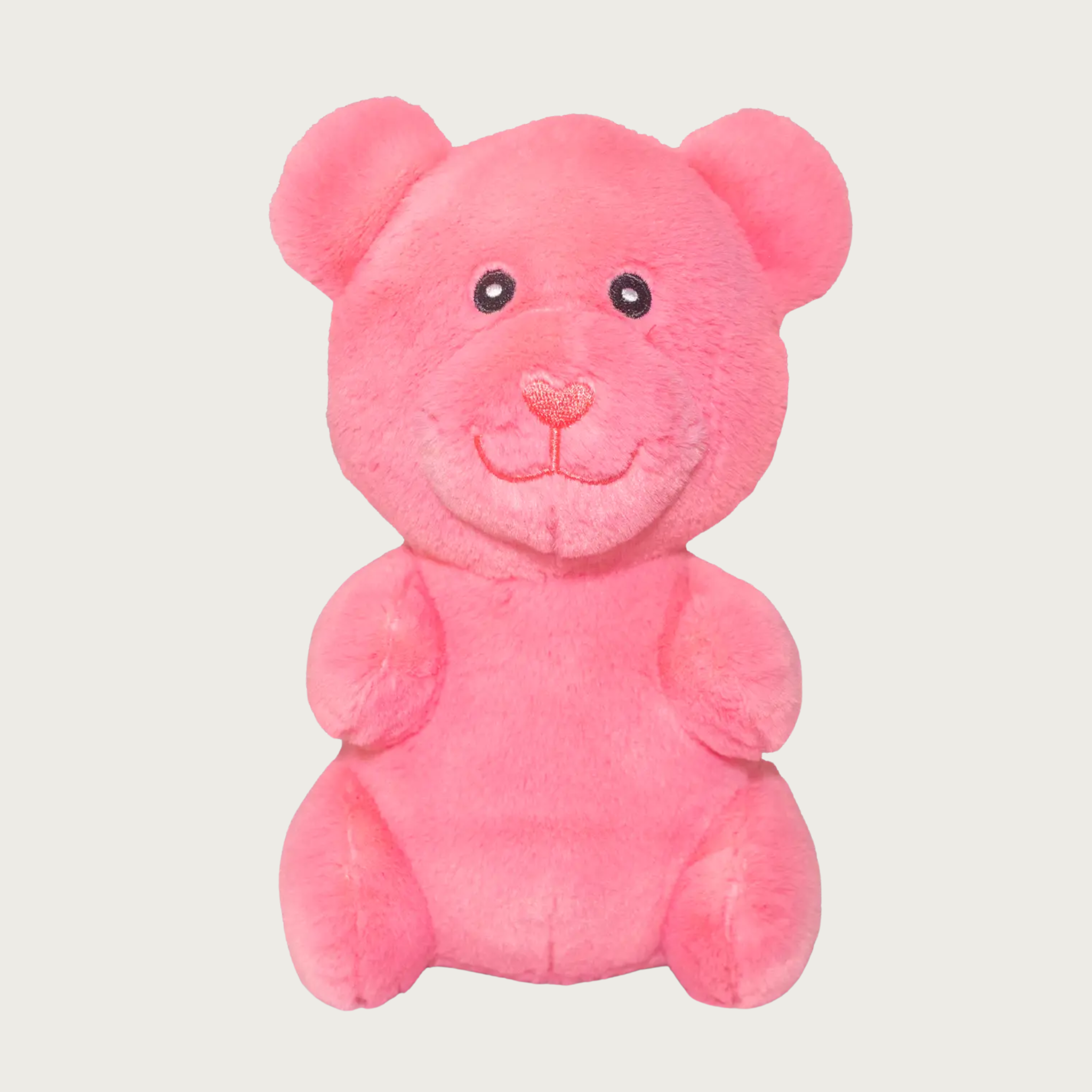 Plush, salmon pink dog toy that looks like a gummy bear.