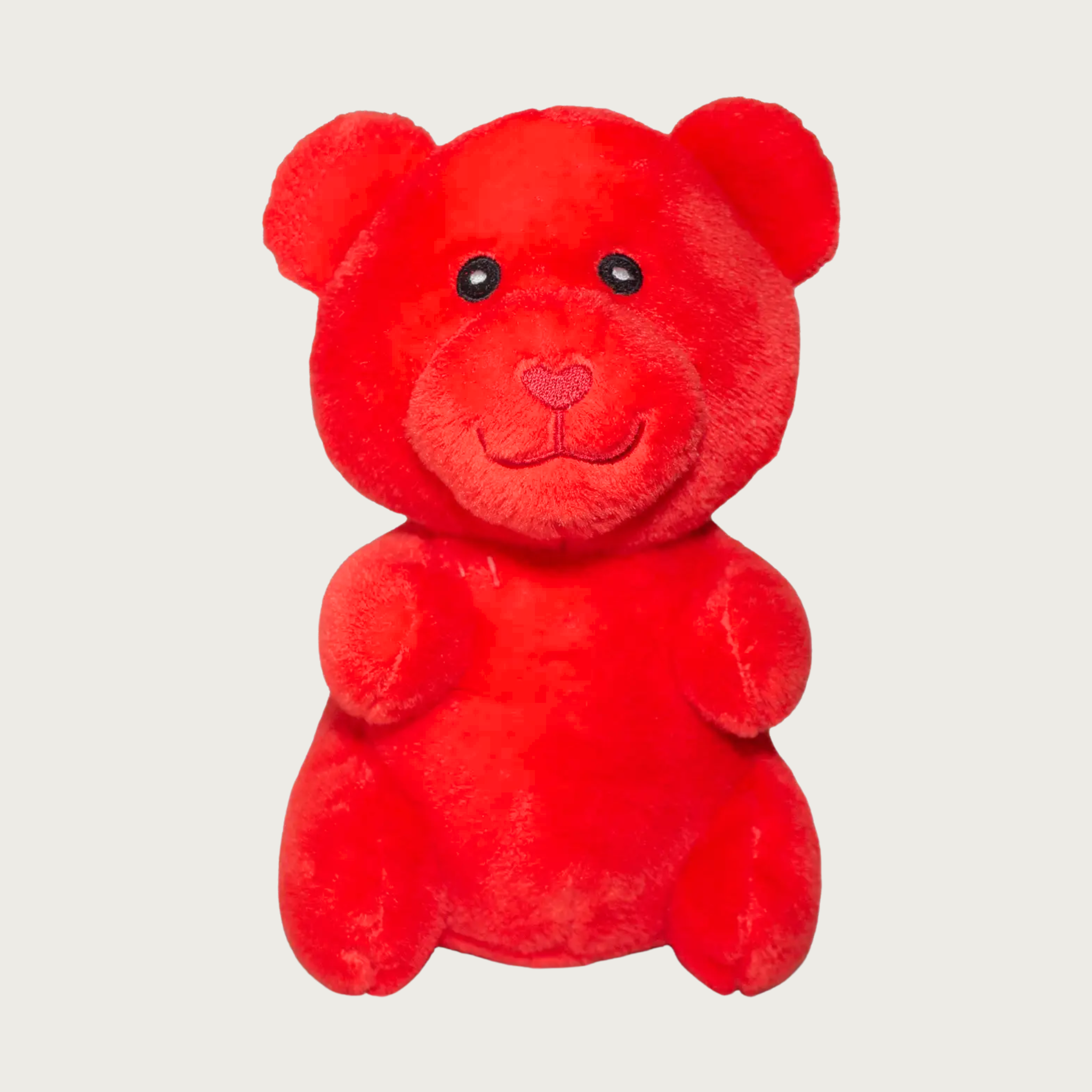Plush, red dog toy that looks like a gummy bear.