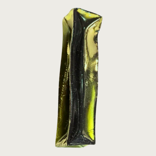 Rectangular stick-shaped, dark green colored dog chew that is transparent.