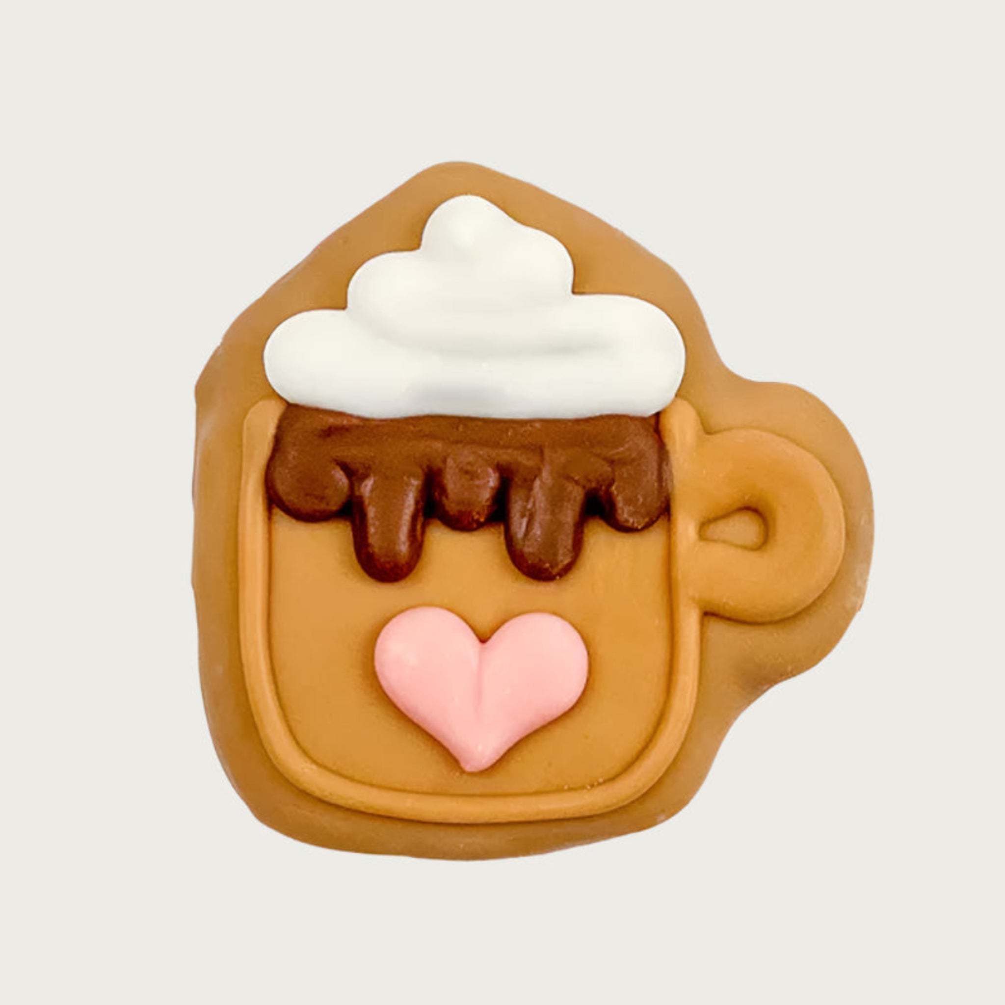 Dog cookie shaped like a coffee mug with whipped cream, "chocolate" drizzle and a pink heart on a tan colored mug.