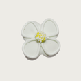 Load image into Gallery viewer, Decorated mini dog cookie shaped like a white daisy flower with yellow center, with white nonpareil sprinkles on top of the yellow center.