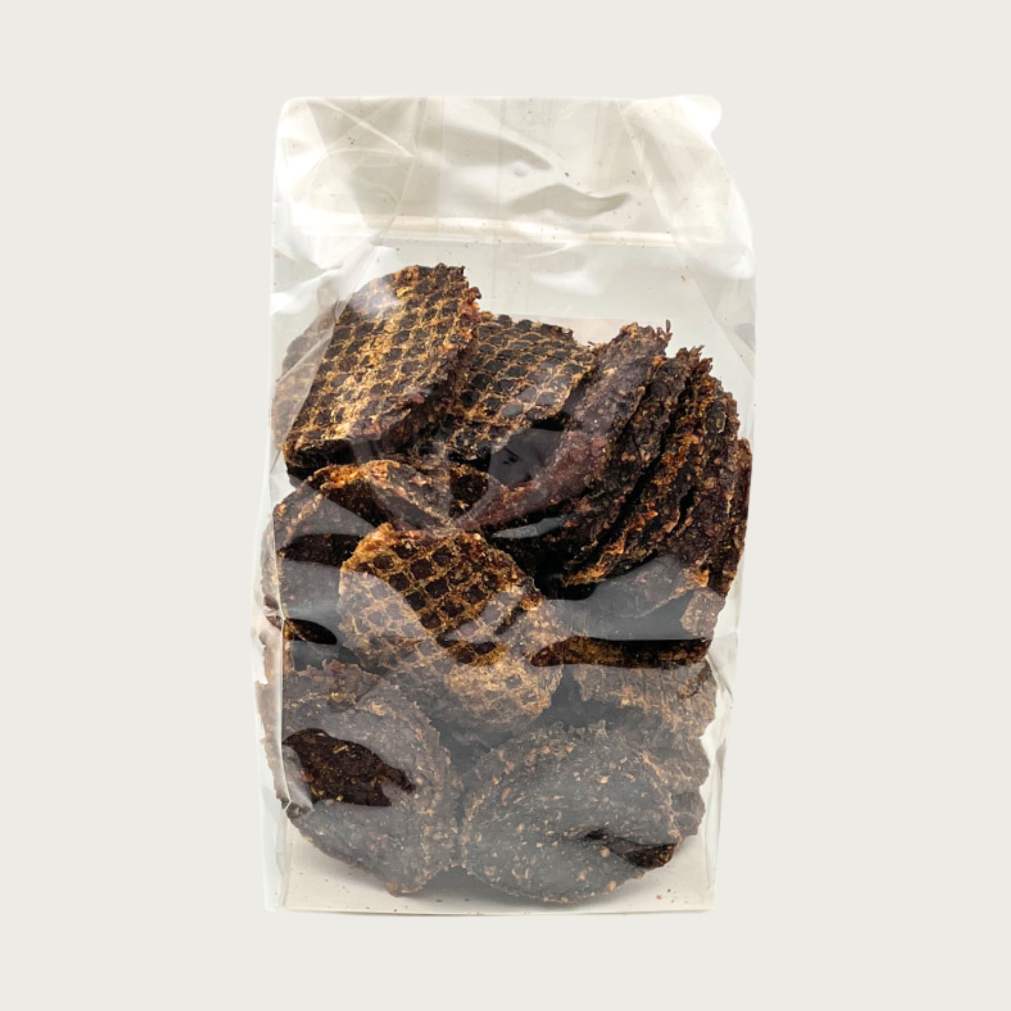 8.5 oz clear, cellophane bag of Wet Nose Thumpers exclusive dog treats. Product inside is visible; they are round, brown treats.