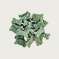 Load image into Gallery viewer, Closeup of a small pile of Minty Breath Bones dog treats. They are dog bone shaped, deep green in color, with a grainy texture.