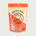 Load image into Gallery viewer, Orange & beige bag of Peanut Butter Pretzels dog treats with simple illustrated line logo for Winnie Lou the Canine Co. in the center. Happily Transparent. Made in Colorado.