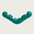 Load image into Gallery viewer, V-shaped, teal colored Bite n' Brush toy from Woof. On each "arm" of the V, there are 2 openings with bristled sides, and one opening at each end of the toy.