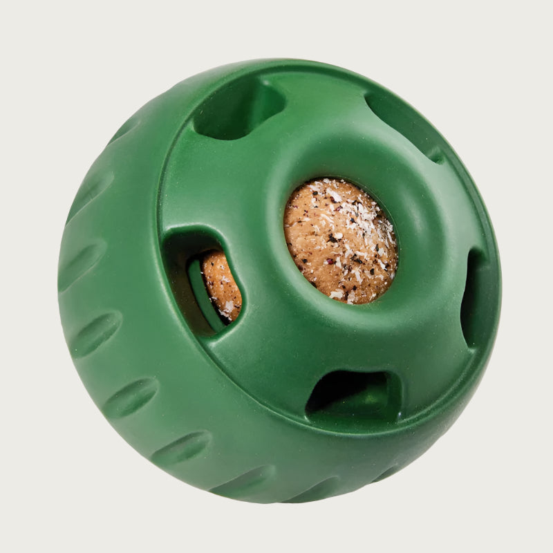 Dark green, round Pupsicle toy. Center has a small, depressed, round open area for dog to access a treat. Around this opening, are 5 smaller slot-type openings (called "drool slots"), to provide additional access and collect excessive drool. Bottom half of toy is solid rubber with an indentation to twist toy apart.