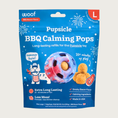 Load image into Gallery viewer, 7 ct bag of large Woof BBQ Calming Pops, long-lasting refill treats for the Pupsicle toy to promote calm. Extra long lasting, less mess. Image of red, white & blue tie-dyed Pupsicle toy is in center, with refill pop inside, with sample pops clustered to the right. They are round, tan colored balls, coated with bacon powder.
