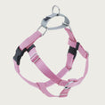 Load image into Gallery viewer, Dog harness with light pink nylon straps on the front and sides; loop on dog's back is light gray. Chest strap is light pink velvet. There are 2 black plastic clips, which fasten behind each front leg.