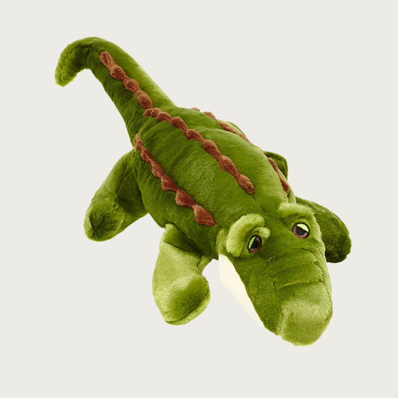 Plush Big Daddy Gator dog toy from Fluff & Tuff.  It is a medium shade of olive green on top, with 3 rows of bumpy brown "scales". Its underside is cream, and it has sleepy brown eyes.