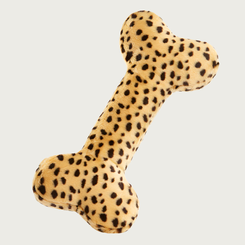 Plush Cheetah Bone dog toy from Fluff & Tuff. This extra-large bone-shaped toy has a cheetah print; beige body with dark brown spots.