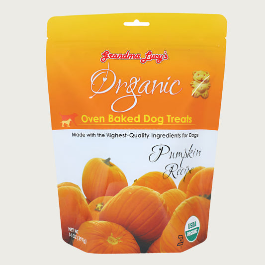 14 oz white & orange colored bag of Grandma Lucy's Organic Oven Baked Dog Treats. Pumpkin Recipe. Made with the highest-quality ingredients for dogs. Photo of a stack of pumpkins is on the bottom half of the bag. A true to size image of the actual teddy bear shaped cookie treat, is near the brand name at top of bag. It's about 2" tall.