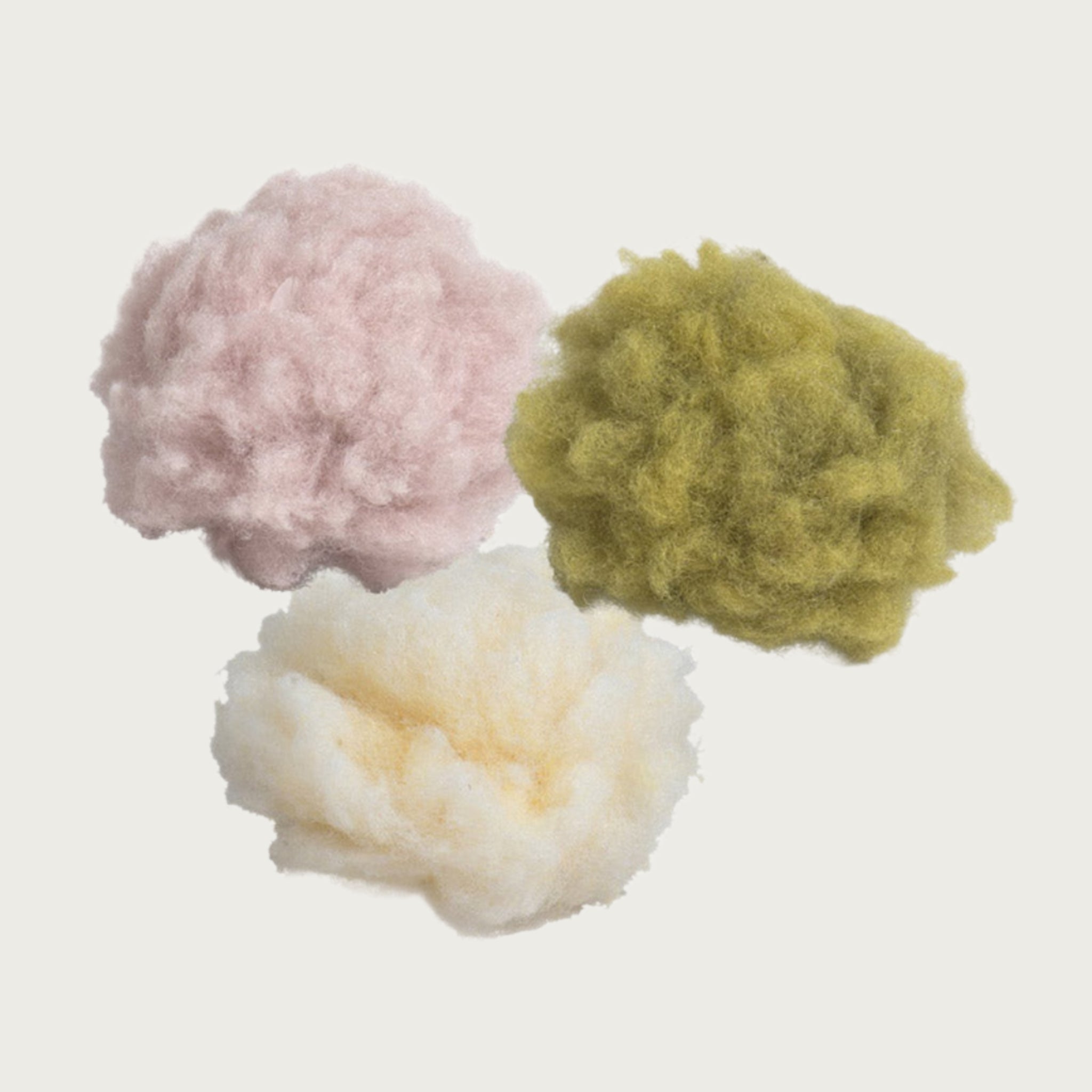 Three fluffy fleece balls, in pink, cream or light green.