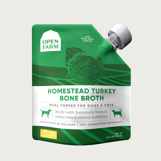 A 12 oz green & white pouch with spout, of Open Farm Homestead Turkey Bone Broth Meal Topper for Dogs & Cats.